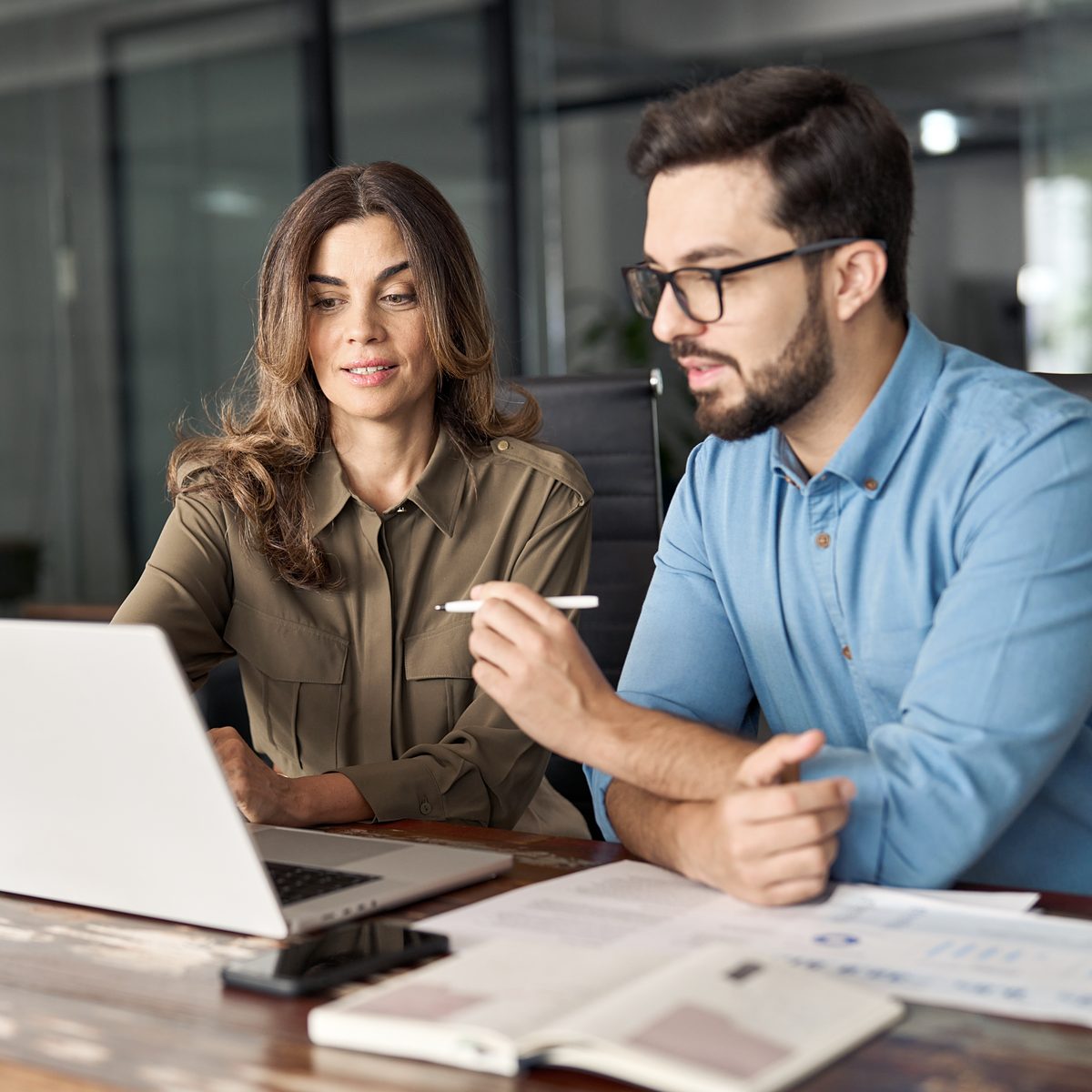 Servidores públicos analisando dados financeiros em um notebook